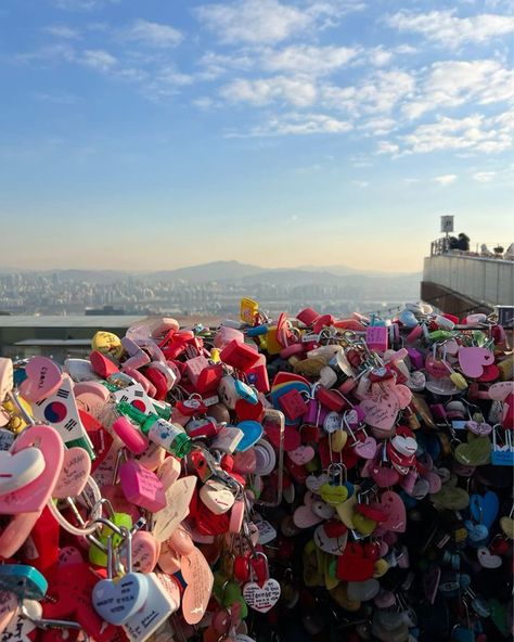 💖🔒✨ Love is in the air at the Love Lock Bridge by Namsan Tower! ✨🔒💖 This magical spot is a must-visit for anyone in Seoul! Couples and friends alike come to attach their love locks, symbolizing their unbreakable bonds. The views of the city from here are absolutely breathtaking! 🌆❤️ Walking along the bridge surrounded by colorful locks and heartfelt messages makes for such a romantic experience. Whether you’re with your special someone or exploring solo, the vibes here are simply enchanting... Seoul Tower, Love Lock Bridge, Namsan Tower, Love Bridge, Love Locks, Lock Bridge, Korea Trip, City Photos, Love Lock