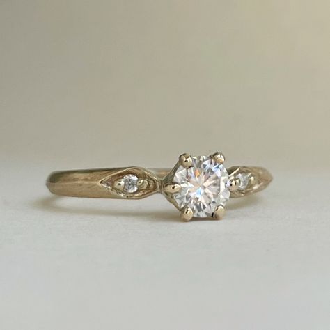 This engagement ring is handcrafted and made to order. band is 2mm x 1.25mm available in 10kt yellow gold and 14kt yellow gold using ethically sourced scs recycled gold. choose your gemstones. lab diamond  white sapphire  moissanite  Center stone 5mm round halve a carat. Side stones are 1.5mm If you want a different gemstone then what is offered please send me a message to discuss I am happy to help. Please allow 2-3 weeks for me to make your ring before shipment. I offer shipping within Canada Vintage Sapphire Engagement Rings, Vintage Solitaire Engagement Ring, Ring Inspiration, Cottage Wedding, Cute Engagement Rings, Sterling Silver Wedding Band, Silver Wedding Bands, Gold Ring Stack, Wedding Band Sets