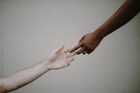 A dark or black skinned hand reaches toward a light or white skinned hand in peace and unity. Their fingers lightly graze to show agreement, listening and friendship. Legends Aesthetic, Caucasian Race, Hawke Dragon Age, Seattle Homes, Cloak And Dagger, Bellatrix Lestrange, Hand Reference, Nursing Mother, Six Of Crows