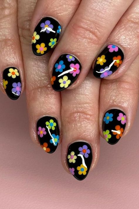 Make a bold statement with this cute nail design by @weekend_nails featuring a sleek black base adorned with vibrant pop-up color flowers, adding a playful and eye-catching contrast for a truly striking look. Looking for fresh nail art inspiration? Look no further! Visit nailustrous.com to delve into our article packed with innovative ideas and step up your nail game like never before! Black Nails With Colorful Flowers, Black And Colorful Nails, Nail Ideas Flowers, Flower Power Nails, Weekend Nails, Fake Nails Black, Nails Short Almond, Nails With Black, Acrylic Manicure