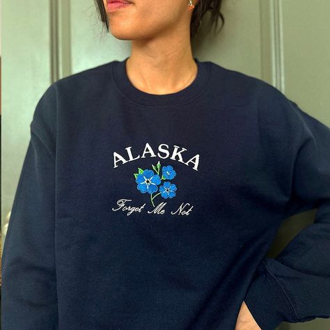 Navy crweneck embroidered with Alaska's national flower, the forget me not. Dark Blue Sweatshirt, Crewneck Outfit, Embroidered Crewneck, Sweatshirt Vintage, Womens Crewneck, 90s Inspired, Blue Sweatshirt, Forget Me Not, Embroidered Sweatshirts