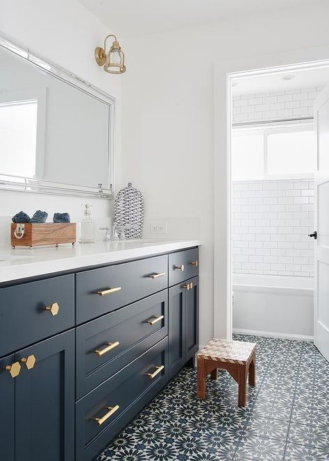 Dark blue shaker bath vanity washstand with brass hexagon pulls and a white quartz countertop finished with a rectangular beaded mirror. Navy Blue Bathroom Cabinets, Blue Bathroom Cabinets, Blue White Bathrooms, Blue Floor Tile, Navy Blue Bathroom, Beach Style Bathroom, Relaxing Bathroom, White Bathroom Designs, Blue Vanity