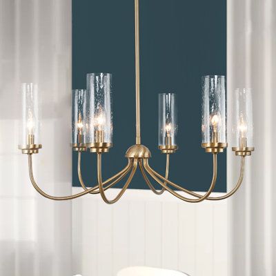 This chandelier is reminiscent of classic candlestick designs but has an updated look that's sure to please. Unveiled with a timelessly contemporary and modern essence, this brass chandelier features six arms softly branch upside for an elegant silhouette. The slim-seeded glass shades on one hand add more visual interest and in another hand produce a romantic atmosphere. Discover the understated luxury touch in the electroplate copper finish. This wagon wheel chandelier ensures plenty of fascina Elegant Dining Room Chandelier, Transitional Dining Chandelier, French Style Chandeliers, Unique Dining Room Light Fixtures, Small Dining Room Chandelier, Over Table Light Fixture, Over Dining Table Lighting, Dining Chandelier Ideas, Gold Chandelier Dining Room