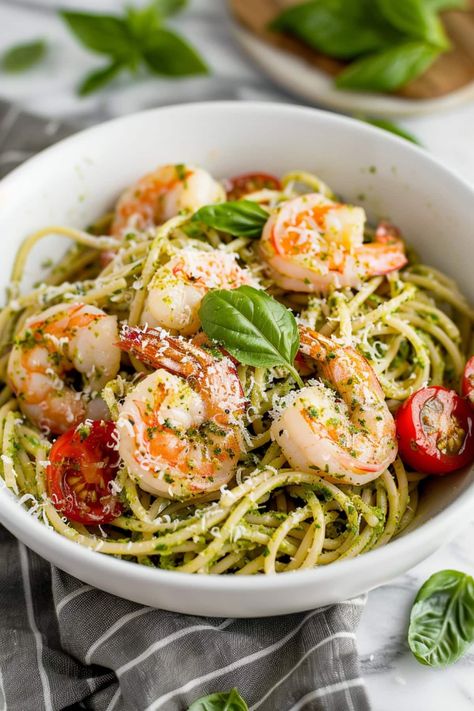 This pesto shrimp pasta features succulent shrimp, salty Parmesan, and bright cherry tomatoes in a garlicky pesto sauce with plenty of tender noodles. Pesto Shrimp Pasta, Shrimp Pesto Pasta, Shrimp Linguine, Pesto Shrimp, Shrimp Noodles, Pesto Pasta Recipes, Yummy Dishes, Dinner Club, Pasta Dinners