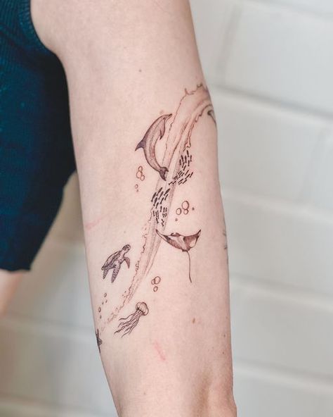 Fine line Tattoo | Single needle Tattoo Perth on Instagram: "Thank you @nevewade63l89____  for allowing me to draw on you.. again 🩵🪼🐋🐬  What do you think about this design? 🐳  #oceanlover #marinelife #fortheoceans #thetinyvegan #veganink #finelinetattoo #singleneedletattoo #whaletattoo #dolphintattoo #marineanimals" Small Fine Line Ocean Tattoos, Fine Line Ocean Animal Tattoos, Tattoo Single Needle, Needle Tattoo, Ocean Tattoo, Dolphins Tattoo, Unique Small Tattoo, Surreal Tattoo, Single Line Tattoo