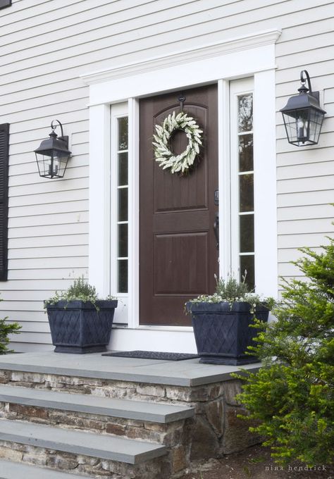 Walnut Planked Wood Door- Modern Farmhouse Home Tour | Nina Hendrick Design Co. | Follow along as a 1980s colonial fixer upper gets a complete DIY makeover and is renovated to reflect modern farmhouse charm. Front Door With Steps Entryway, Stone Stairs Front Door, Front Stoop Makeover Concrete, Masonry Front Steps, Colonial Front Steps, Diy Front Door Steps, Front Door Landing Exterior, Stone Front Steps Entrance, Granite Front Steps