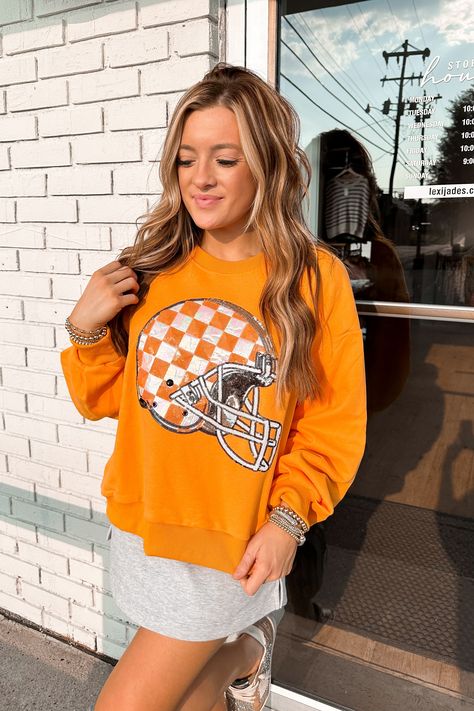 Queen Of Sparkles Licensed Orange Tenn Checkered Helmet Sweatshirt Product Details Queen Of Sparkles QOS Tennessee Vols Helmet Sweatshirt TN Volunteers Checkered Helmet Outfit Vols Gameday Fit Crew neck sweatshirt Long sleeves Sequins Measurements (Measurements are approximate and are taken laying flat) - XS - Bust 26", Length 23" S - Bust 27", Length 24" M - Bust 28", Length 25" L - Bust 29.5", Length 26" XL - Bust 31", Length 28" Sporty Game Day Outfit, Tn Vols Gameday Outfit, Sec Gameday Outfits, Tn Vols, Queen Of Sparkles, Tennessee Vols, Long Sleeve Sequin, Gameday Outfit, Hoodie Top