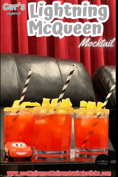 This image shows three red drinks with a yellow rim, pineapple garnish and black and white striped straws in a home movie theater with a Lightning Mcqueen car sitting next to them. Disney Themed Drinks, Disney Movie Night Menu, Disney Themed Movie Night, Disney Movie Night Food, Disney Movie Night Dinner, Disney Cars Movie, Movie Night Dinner, Movie Night Food, Disney Drinks