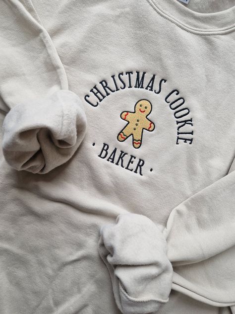 Christmas cookie baker sweatshirts 🍪 Tired of seeing fake branded sweatshirts & hoodies and want something a little more original? I GOT YOU!  This beige sweatshirt features a pullover design, oversized silhouette. Great sweatshirt for all year around.  * Drop shoulder style  * Air jet spun yarn for a softer feel and anti pill  * Rib trim with spandex at cuffs and hem  * Twin needle stitching Fabric: 50% Cotton 50%  Polyester  Product colour may slightly vary due to lighting or your monitor set Outfit For Christmas, Beige Sweatshirt, Couples Outfit, Couples Sweatshirts, Matching Couple Outfits, Christmas Hoodies, Shirt Embroidery, Winter Clothing, Branded Sweatshirts