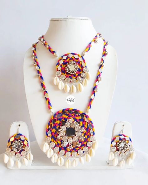 Are you someone who's already been shopping for her Navratri look? Checkout this beautiful Multicolored jewellery set adorned with lots of mirrors, Cowrie shells, coins and ghungroo to match your Garba Vibes for this Navratri Season 🔥 This 2 layered long necklace and earrings makes you stand out in the crowd and match perfectly with every outfit ❤️ Visit indiashaat.com for more handmade jewellery options #indiashaat #navratrijewellery #bohojewellery #multicolorjewellery #letajaijo [Ha... Handmade Navratri Jewellery, Necklace For Navratri, Navratri Necklace, Garba Jewellery, Navratri Look, Navratri Jewellery, Navratri Collection, Mirror Jewelry, Diy Fabric Jewellery