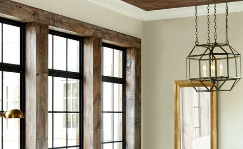 Chunky wood trim with storefront windows Black Window Stained Trim, Black Windows Stained Wood Trim, Interior Window Trim Black Windows, Wood Trim Black Windows, Black Framed Windows Living Room, Wood Trim With Black Windows, Black Window Wood Trim, Black Window With Wood Trim, Stained Window Trim Ideas Interior