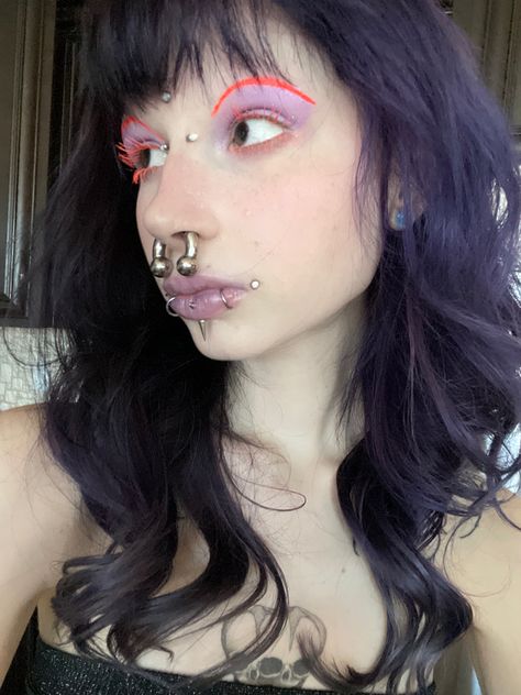 purple hair, dahlia bites, dahlia piercing, 2g septum, purple hair, unconventional makeup, orange makeup, purple makeup, orange and purple makeup, orange mascara, orange lashes, bridge piercing, forehead dermal, third eye piercing, snake bites, opal piercings Forehead Dermal Piercing, 2g Septum, Dalia Piercing, Piercing Set Up Face, Dahlia Bites Piercing, Forehead Dermal, Orange And Purple Makeup, Orange Mascara, Orange Lashes