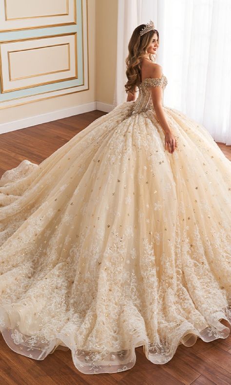 Off-the-shoulder quinceanera dress with a corset bodice and lace embroidery. Yellow Gold Quinceanera Dresses, Champagne Dress Quinceanera, Quinceanera Champagne Dress, White Sweet Sixteen Dresses, Cream Color Quinceanera Dress, Champagne Xv Dresses, Gold Dresses Quinceanera, White Xv Dresses, Ivory Quinceanera Dresses