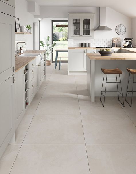 Introducing our exquisite Capri Travertine Stone porcelain floor tiles, a perfect blend of sophistication and durability for your home. Crafted with meticulous attention to detail, these tiles add a touch of class to any room and create a seamless and expansive look for your home. Resistant to stains, scratches, and wear, these tiles offer both style and practicality, making them an ideal choice for high-traffic areas. Elevate your home with the versatility and charm of these premium porcelain floor tiles.  Capri Travertine Stone boasting a soft, neutral hue that effortlessly complements various design aesthetics and seamlessly blends sophistication with durability.     Available in 60cm x 60cm and 80cm x 80cm tile sizes. White Cabinets Stone Floor, Kitchen Floors Ideas Tile, White Kitchen With Travertine Floors, Neutral Interior Design Kitchen, Kitchen Floor Tile Design Ideas, Japandi Kitchen Floor Tiles, Cream Kitchen Floor Tiles, Kitchen With Stone Floor, Kitchen White Tile Floor