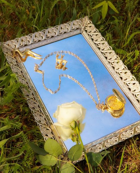 Dreamy aesthetic / cottagecore / nature / vintage jewelry / subscription box / gold locket / necklace / pendant / gold and pearl / broach / product photography / small business / michigan / outdoors photoshoot / mirror tray / blue skies / white rose / flower photography / jewelry Vintage Jewelry Shoot Ideas, Jewelry Water Photography, Nature Jewelry Photoshoot, Picnic Jewelry Photoshoot, Vintage Jewelry Photoshoot, How To Take Pictures Of Jewelry, Outdoor Jewelry Photography, Jewllery Ideas Photography, Photographing Clothes