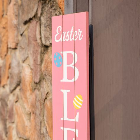 "Buy Glitzhome® 60'' Easter Blessings Wooden Porch Sign at Michaels. com. A festive piece that makes a perfect addition to your Easter holiday decorative theme. Bring a merry touch to your Easter using this vertical porch leaner. It features EASTER BLESSINGS printed in white on a pink background and slatted design. The words are also accented with colorful eggs, bringing a vibrant appeal to your Easter décor! Details: Easter Blessings Wooden Porch Sign design 7.25'' x 1'' x 60'' 4.62 lb. Handcra Colorful Eggs, Wooden Porch, Easter Blessings, Moving And Storage, Host Gifts, Outdoor Material, Spring Painting, Easter Decorations Outdoor, Egg Designs