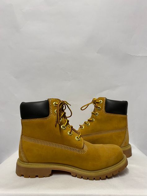 The classic original yellow leather work boot. Featuring a soft yellow upper with brown padded leather ankle cuffs and nut brass eyelets. Details Condition: Used - In very good condition. - signs of used to soles and a small mark to leather upper. (please see photos). Material: leather Brand: Timberland Colour: Yellow, Brown Size: 4 Heel height: 1.1 inches Leather Work Boots, Work Boot, Soft Yellow, Colour Yellow, Leather Work, Yellow Leather, Ankle Cuffs, Work Boots, Leather Upper