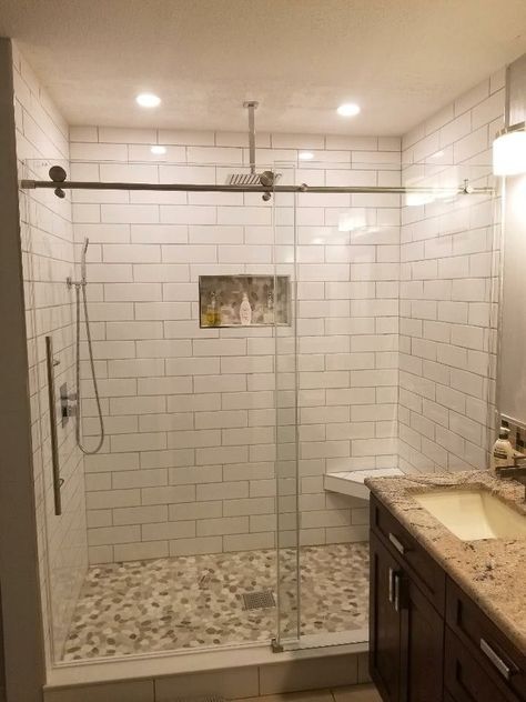 Bathroom Tile Pebble Floor, Subway Tile With Pebble Floor, Walk In Shower With Pebble Floor, Pebble Shower Ideas, White Subway Tile Shower Pebble Floor, Shower Pebble Tile Ideas, Pebble Shower Floor With Subway Tile, Pebble Tile Shower Ideas, Pebble Floor Shower Ideas