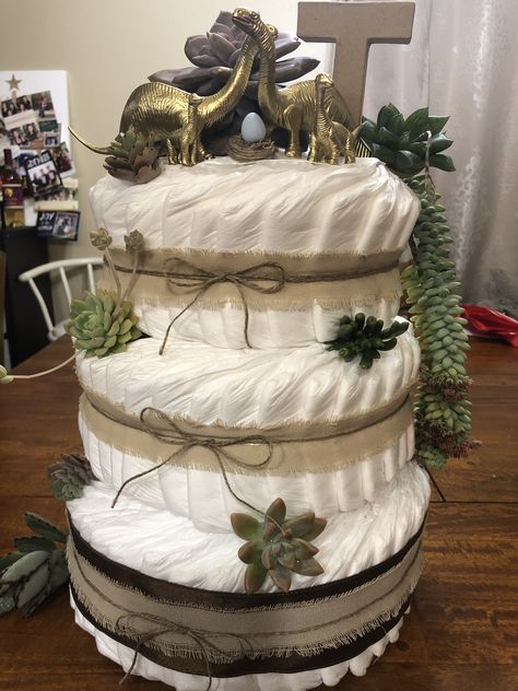 Dino diaper cake Dino Baby Shower Cake, Dinosaur Diaper Cake, Dinosaur Nappy Cake, Diaper Cake Dinosaur Theme, Tractor Diaper Cake Tutorial, Kate Baby, Diy Diaper Cake, Diaper Sculpture Shower Gifts, Dino Cake