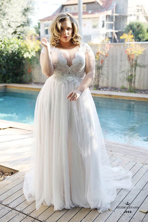 Jess is a boho inspired wedding dress that is all about the romantic details. The plunging scalloped v-neckline, sequined bodice, lace cap sleeves, and flowy tulle skirt are what boho dreams are made of. Bridal Dress Plus Size, Simple Plus Size Wedding Dresses, Studio Levana, Beach Bridal Dresses, Plus Wedding Dresses, Gonna In Tulle, Plus Size Wedding Dress, Plus Size Brides, Plus Size Wedding Gowns