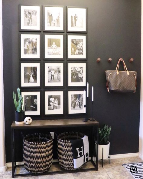 Entryway Wall Pictures, Black Wall With Black Picture Frames, Decorating With Black And White Photos, Black Wall With Black Frames, Black Picture Wall Ideas, Black Wall Entryway Ideas, Purse Hooks Wall Entryway, Entryway Ideas Black Wall, Black Wall With Picture Frames