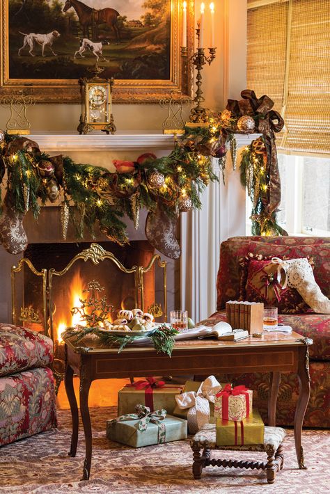 The scrolling ribbons, vintage ornaments, and other adornments of this exuberant garland offer a fitting complement to the richly hued upholstery and rug. Victoria Magazine, English Christmas, Christmas Fireplace Decor, Christmas Mantel Decorations, Christmas Interiors, Christmas Mantle, Christmas Fireplace, Christmas Mantels, Victorian Christmas