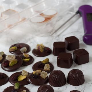 Selection of homemade chocolates by recipes made easy with chocolate moulds and thermometer on the side Chocolate Desserts Fancy, Tempered Chocolate, Temper Chocolate, Chocolate At Home, Healthy Chocolate Desserts, Homemade Chocolates, Chocolate Moulds, How To Temper Chocolate, Chocolate Candy Recipes