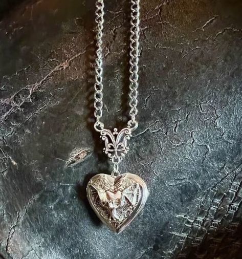 This heart shaped bat locket has a beautiful silver shine and is a metal alloy. The locket measures 1.2 inches by 1.2 inches in size. The chain is 20 inches with a 2-inch extension. The 3 D ancient style embracing skeletons in flat coffin pendant measures 1 inch tall by .4 inches wide. The skeleton bodies thickness from the sides measures .6 inches in thickness and exposes the entire side of the skeletons.                                                                            Shipping is free and shipped to customer within 1 business day from Scottsdale, Az. Vampire Jewelry, Bat Jewelry, Gothic Pendant, Bat Earrings, Necklace Gothic, Gothic Earrings, Heart Locket Necklace, Gothic Necklace, Skull Jewelry