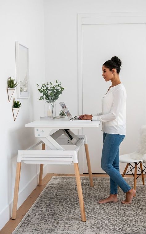 Inscape, a local office furniture supplier with a sleek showroom at Bay and Wellington, recently updated one of their popular office desks for the home. The Scandinavian-inspired design—available in a white or walnut surface with pale wood or metal legs—is unassuming when it’s lowered but lifts easily up and slightly forward to ergonomically complement a good standing position. Mcm Adjustable Desk, Small Adjustable Standing Desk, Home Office 2 Monitors Computer Desks, Sitting And Standing Desk, Sit To Stand Desk Home Office, Stand Up Desk Decor, Home Office For Small Spaces Bedroom, Sit And Stand Desk Home Office, Built In Adjustable Standing Desk