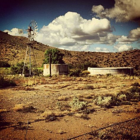 The Karoo is a semi-desert natural region of South Africa. There is no exact definition of what constitutes the Karoo, and therefore its extent is also not precisely defined. The Karoo is partly defined by its topography, geology, and climate — above all, its low rainfall, arid air, cloudless skies, and extremes of heat and cold. The Karoo also hosted a well-preserved ecosystem hundreds of million years ago which is now represented by many fossils........#travel #holiday #vacation #safari #touri Karoo Landscape, Farmhouse Photography, Garden Centers, Africa Do Sul, South Africa Travel, Flowers Beautiful, Holiday Tops, Southern Africa, Countries Of The World