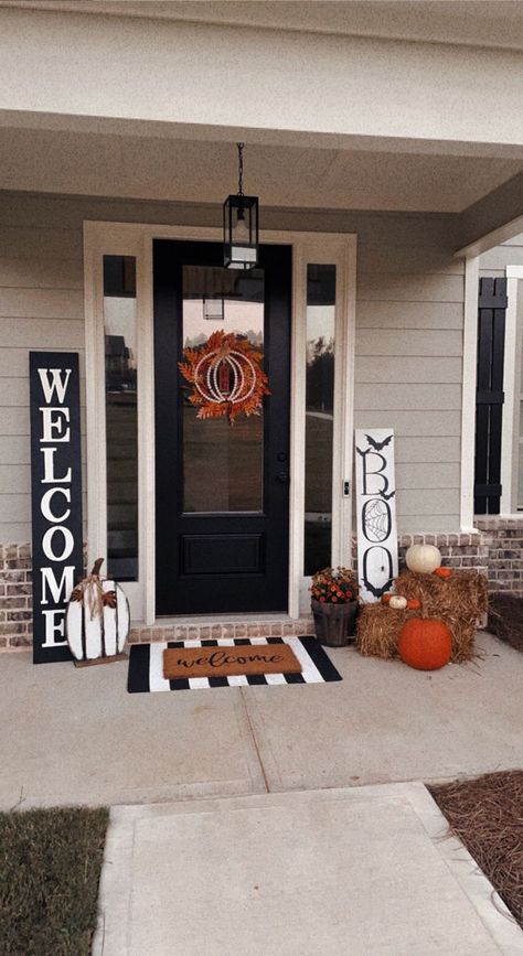 Loving my front porch this year! Here's everything included: 
Custom-made black and white welcome sign
'Boo' sign from Bealls Outlet
Ornage wreath from Amazon
Pumpkin on wreath from Big Lots
Wood Pumpkin from Hobby Lobby
Welcome mat from Amazon
Striped rug from Amazon
Hay Bales from Hobby Lobby
Mums and pumpkins from Home Depot

minimalist fall decor for front porch Pumpkins Small Front Porch, Black White Fall Porch, Home Depot Doors Front Porches, Black White And Orange Fall Decor Porch, Halloween Decorations Hobby Lobby, Hay Porch Decor, Small Porch Mum Decor, Mums Pumpkins Front Porch, Entryway Halloween Decorations