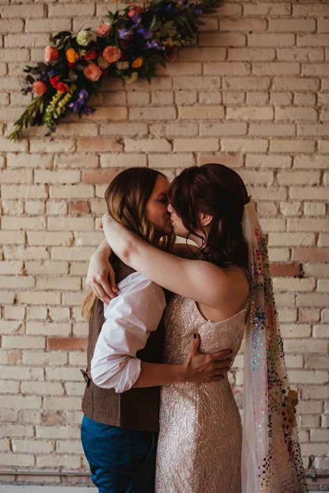 Two brides | queer wedding | lesbian wedding rainbow wedding cake with sprinkles | pinball date | wedding veil with sequins | rainbow wedding veil | champagne wedding gown | rainbow wedding flowers | custom cookies for LGBTQ+ couple | custom cocktail ideas for weddings | wedding cocktails | colorful photo booth idea for wedding reception | Samantha Joy Photo Western Lesbian Wedding, Outdoor Lesbian Wedding, Trans Wedding Ideas, Lesbian Wedding Color Schemes, Lesbian Country Wedding, Queer Wedding Ideas, Rainbow Wedding Flowers, Sapphic Wedding, Lesbian Wedding Outfits