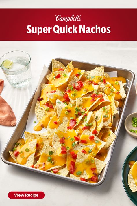 Want to know what we love most about these Super Quick Nachos? That the spicy cheese sauce stays creamy and doesn't glue all the chips together like shredded cheese does. It's also made with 2 ingredients you usually have on hand, condensed soup and milk. The Condensed Spicy Nacho Cheese Soup is the hero in this recipe, coating tortilla chips in warm spicy cheesiness. We love them with fresh cilantro and tomato, but you can add any of your favorite nacho toppings, perfect for game day! Nacho Cheese Soup Recipe, Nacho Cheese Soup, Quick Nachos, Spicy Cheese Sauce, Spicy Soups, Tomato Soup Healthy, Nacho Toppings, Campbells Soup Recipes, Campbells Recipes