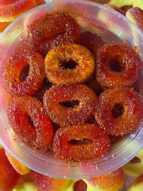 Peach rings candy coated with chamoy and topped with homemade chili powder. Chamoy Peach Rings, Candied Peaches, Peach Rings Candy, Chamoy Candy, Homemade Chili Powder, Bell Gardens, Mexican Snacks, Kawaii Cooking, Junk Food Snacks