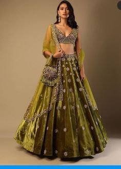 Lehenga Choli for Wedding Wear is stunningly embroidered in dabka, tilla, and sequins work on white raw silk choli paired with Raw Silk Green Lehenga and Net Pink Dupatta. ﻿A blossoming pink hue dupatta is paired up with a handcrafted mastery of pearls, zardosi, and sequins laid over an emerald green lehenga and a white choli in pure raw silk. Choli: Beautiful dress is gonna make your big day more beautiful in its design and styling having embroidered choli in without sleeves inc Long Gown For Wedding, Velvet Lehenga, Wedding Lehenga Designs, Kalki Fashion, Green Lehenga, Embroidered Velvet, Lehenga Designs, Indian Designer Outfits, Indian Fashion Dresses