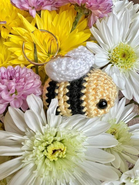 🐝 Bring a touch of whimsy to your daily essentials with this adorable crochet bee keychain!  🍯 This little bee makes a thoughtful and heartwarming present for birthdays, holidays, or the random Tuesday! Treat yourself or surprise a friend with this adorable accessory! Crochet Bee Keychain, Bee Keychain, Bee Free, Handmade Plushies, Crochet Bee, Keychain Handmade, Adorable Crochet, Keychain Cute, Bee Design