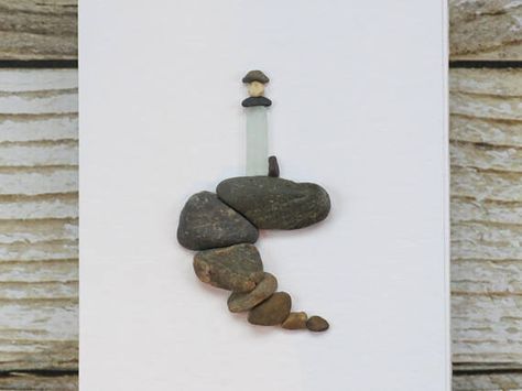 Pebble Art Lighthouse Made of sea glass and beach pebbles! Comes in a black wooden frame with glass and is ready for wall or tabletop display! Frame measures about 6x8 and is matted to 5.5x3.5 Thanks so much for looking!:) Sea Glass Lighthouse, Lighthouse Gifts, Lighthouse Decor, Stone Pictures Pebble Art, Sea Glass Art Projects, Drukarka 3d, Beach Pebbles, Driftwood Wall Art, Lighthouse Art