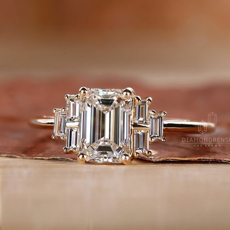 Our Emerald Cut Diamond Engagement Ring, a masterpiece that symbolizes eternal love. Featuring a breathtaking emerald cut center diamond, flanked by exquisite side baguette cut diamonds, this ring is more than a piece of jewelry - it's a testament to your unique love story. Crafted with IGI certified lab-grown diamonds, our ring promises not only unmatched beauty but also an ethical and sustainable choice. Three Stone Engagement Ring Specifications: ● 𝐂𝐞𝐧𝐭𝐞𝐫 𝐃𝐢𝐚𝐦𝐨𝐧𝐝 𝐃𝐞𝐭𝐚𝐢𝐥𝐬 → Needle Baguette Engagement Ring, Unique Emerald Cut Engagement Rings, Ring Marriage, Vintage Style Wedding Rings, Emerald Cut Diamond Engagement Ring, Emerald Cut Diamond Engagement, Emerald Cut Diamond Ring, Emerald Cut Rings, Emerald Cut Diamond