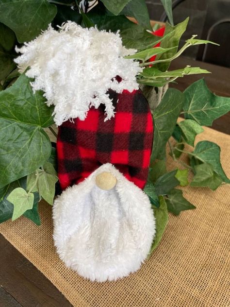 Calling all you gnome lovers!!Here is a cute way to make your own adorable gnome friend for only $2. This fun holiday DIY is kid friendly too and would make a great activity for all ages. Here is a picture of everything you need:Slipper (I got these at the Dollar Tree. I love buffalo plaid)1” wood bead4 inch board or piece of cardboardYarnscissorshot glue First step:Take your slipper and fold the heel over. If you are a visual learner, I also made a YouTube video showing how to mak… Gnome Bunny, Gnome Diy, Bunny Slippers, Gnomes Diy, Dollar Store Christmas, Diy Gnomes, Christmas Door Hanger, Christmas Swags, Gnomes Crafts