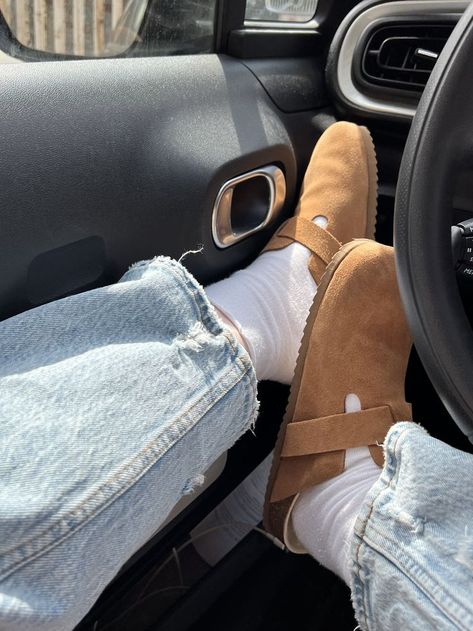 a girl sitting in a car wearing brown slide on shoed with white socks and blue Abercrombie jeans. She has her feet up to show the shoes Emma Chamberlain Birkenstock Clogs, Boston Burken Stocks, Emma Chamberlain Birkenstocks, Boston Sandals Outfit, Boston Berkinstocks Outfit Men, Birkenstock Boston Mink Outfit, Mink Birkenstock Outfit, Birkenstock Boston Brown Outfit, Birken Stock Boston