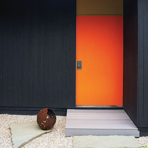 Dark House Bright Door, Bright Orange Front Door, Black House Orange Door, Mid Century Doors Entrance, Orange Doors On Houses, Orange Doors Exterior, Front Door Brick House, Orange Front Door, House Mid Century