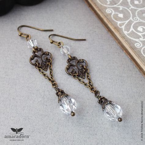 These elegant but unusual earrings feature antiqued bronze finish gothic floral components combined with chains and clear crystal tear drops. Attached to bronze plated ear wires for pierced ears - choose from hooks, lever backs or simple clip-ons.  Each earring is approx. 6.7cm (2.6") long from the top of the ear wire. You will receive one pair. Ready to ship - All items are carefully wrapped in tissue paper and then placed within a black organza gift bag plus a slim mailing box for extra protec Dark Academia Earrings, Victorian Bronze Earrings For Gift, Antique Intricate Drop Earrings, Handmade Victorian Bronze Earrings, Black Victorian Dangle Jewelry, Ornate Bronze Drop Earrings, Dark Academia Jewelry, Antique Bronze Jewelry, Victorian Style Earrings