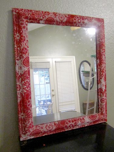 DIY- fabric-covered mirror Fabric Covered Mirror Frame, Diy Fabric Mirror Frame, Mirror Lights Ideas, Mirror Border Diy, Decoupage Mirror, Covered Mirror, Living Room Wall Mirror, Diy Mirrors, Room Wall Mirror