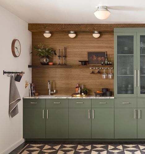 Wooden Kitchen Cabinets With Wood Floors, Green Cabnit Kitchen, Wood Paneling Kitchen, Modern Earthy Kitchen, Wood And Green Kitchen, Warm Toned Kitchen, School House Lighting, Wall Lights Bedroom, Black Ash