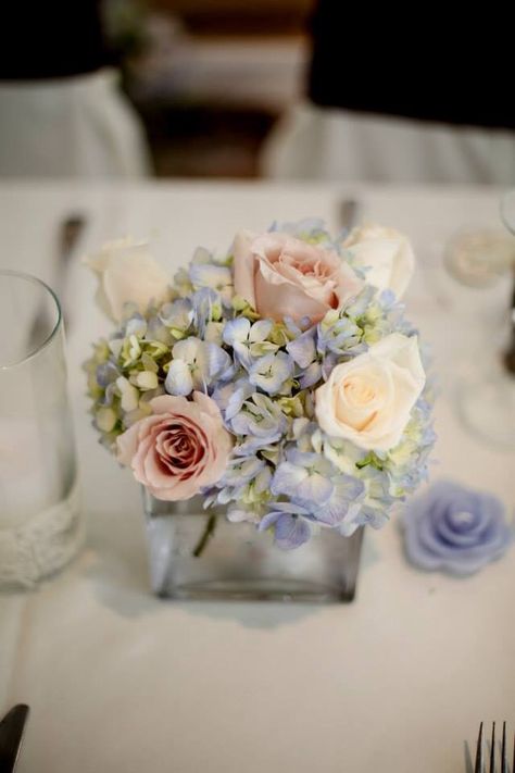 Small wedding centerpieces. Blue hydrangea and pale pink roses Pink And Blue Flower Centerpieces, Small Flower Centerpieces Birthday, Blue Hydrangea Pink Roses, Dusty Blue And Blush Pink Wedding Centerpieces, Peonies And Hydrangeas Centerpieces, Small Hydrangea Arrangements, Pink And Blue Floral Centerpieces, Centerpieces Wedding Hydrangea, Blue Pink And White Floral Arrangements