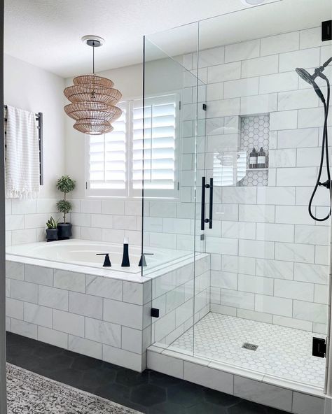 This white bathroom boasts a white and gray marble tiled drop-in tub with black faucet. A seamless glass and matching marble tile shower next to the tub features a marble hexagon tile niche and black shower kit. Tub Next To Shower Ideas, Tile Niche, Bathroom With Tub, Master Bath Shower, Black Faucet, Hexagon Tile, Bathroom Redesign, Bad Inspiration, Shower Kit