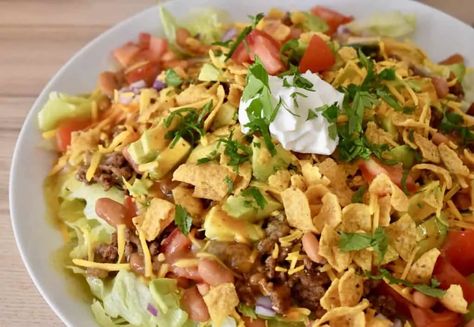 Frito Taco Salad is the BEST taco salad recipe! Made with Frito chips, ground beef, cheddar, French or Catalina dressing, and green taco sauce. #fritotacosalad #tacosalad Recipe With Fritos, The Best Taco Salad Recipe, Frito Taco Salad, Frito Recipe, Catalina Dressing, Taco Salad Recipe, Chicken Taco Seasoning, Sausage Hash, Fajita Bowls