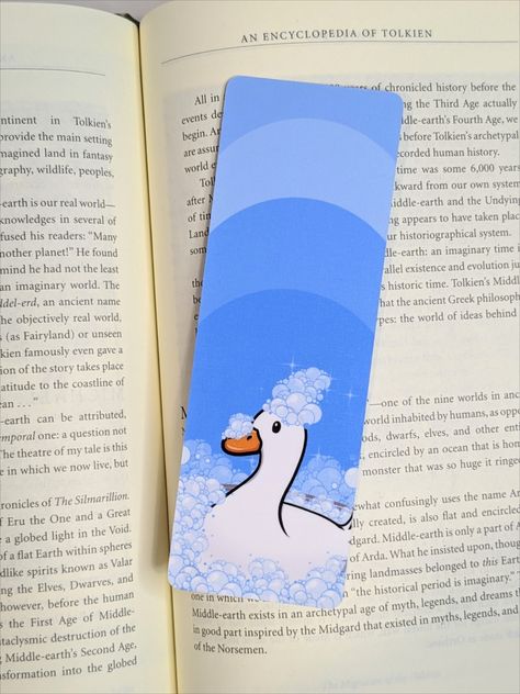 Double sided laminated handmade bookmark. The design is a white duck in a bubble bath with a bunch of bubbles on his head. Background is shades of blue. Has rounded corners. Duck Bookmark, Bath Duck, Duck Drawing, Cottagecore Gifts, Bookmark Handmade, Reading Accessories, Cute Duck, Easy Canvas Art, Book Markers