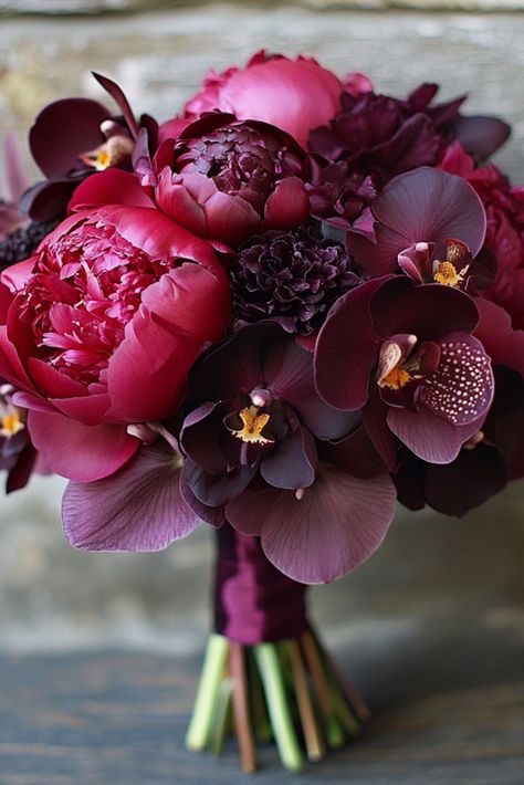 Deep plum orchids, rich wine-hued peonies, and sultry burgundy tones take center stage here. This purple wedding bouquet is for the bride who loves a bold statement with a sophisticated edge. Ready to turn heads with this dramatic beauty? Bring this luxe bouquet idea to life for your big day. Victorian Bridal Bouquet, Burgundy Wedding Inspiration, Plum Color Flowers, Burgundy Peony Bouquet, November Wedding Bouquet, Wedding Bouquets September, Purple Wedding Aesthetic, Wedding Bouquets Burgundy, Red Peony Bouquet