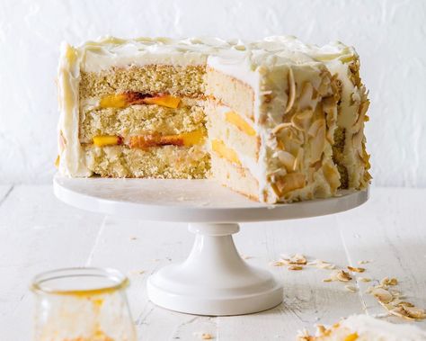 Blending one traditional Southern classic, the cloud-like coconut cake, with blushing stone fruit, this triple-layer cake is an undeniable showstopper. A final coating of toasted coconut flakes brings a dash of color to the typically snowy-white appearance. Save Recipe Print Coconut Peach Cake   Makes 1 (9-inch) cake Ingredients 1½ cups (340 grams) unsalted butter, … American Buttercream Recipe, Triple Layer Cake, Cake Mug, Simple Syrup Recipes, Peach Cake, Buttercream Recipe, Peach Recipe, Coconut Recipes, Syrup Recipe